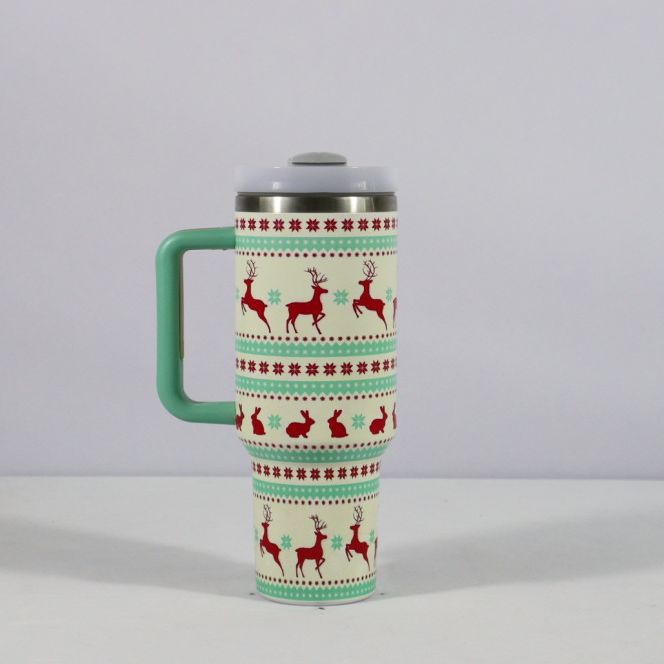 Christmas pattern mug with festive reindeer design and green handle, perfect for holiday beverages.