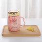 Marbling mug set with colorful designs and gold accents, perfect for stylish coffee lovers.