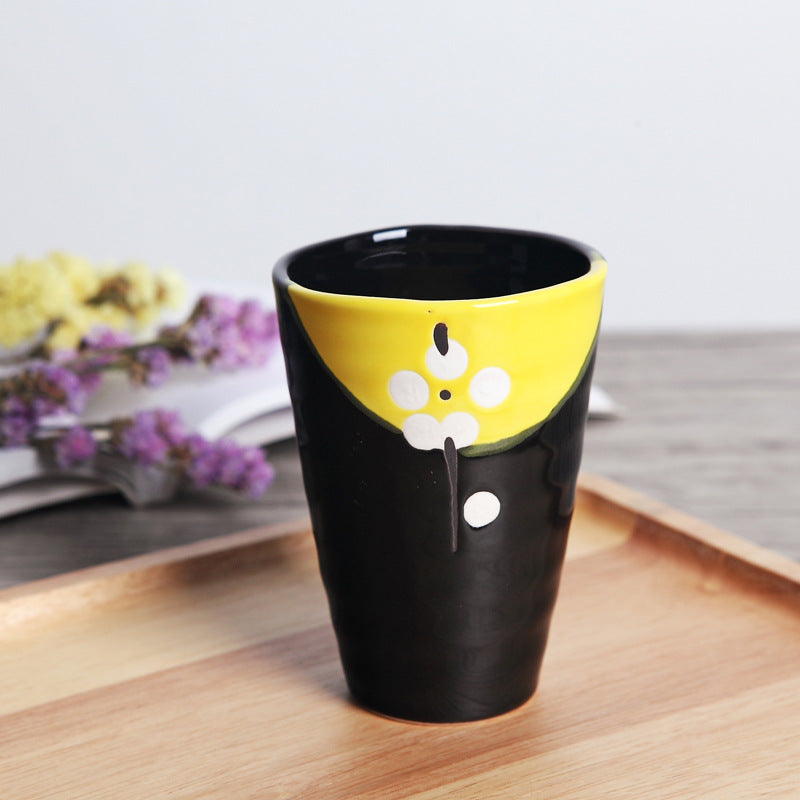 Japanese ceramic mug featuring a delicate flower pattern and elegant round shape on a wooden surface.