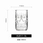 Transparent drinkware featuring unique embossed face designs in six cylindrical glass mugs.