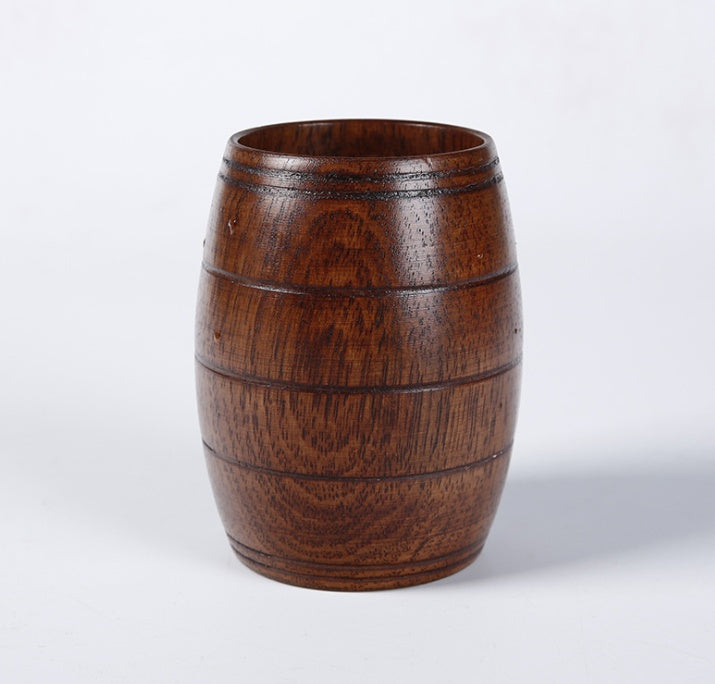 Wooden tea cup made of polished wood, featuring a barrel shape and a rich dark wood color, perfect for serving beverages.