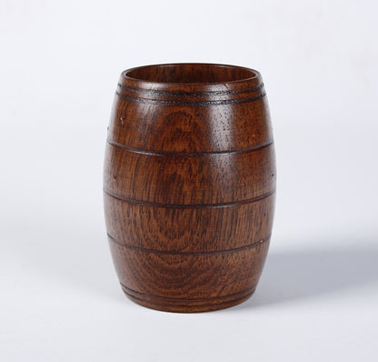 Wooden tea cup made of polished wood, featuring a barrel shape and a rich dark wood color, perfect for serving beverages.