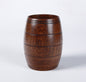 Wooden tea cup made of polished wood, featuring a barrel shape and a rich dark wood color, perfect for serving beverages.