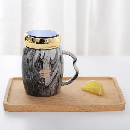 Marbling mug set with colorful designs and gold accents, perfect for stylish coffee lovers.