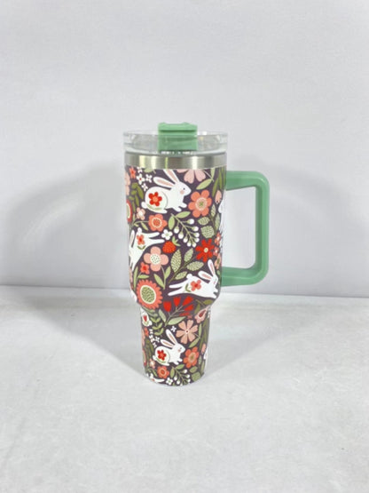 Christmas pattern mug with festive reindeer design and green handle, perfect for holiday beverages.