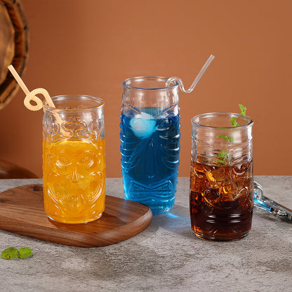 Transparent drinkware featuring unique embossed face designs in six cylindrical glass mugs.