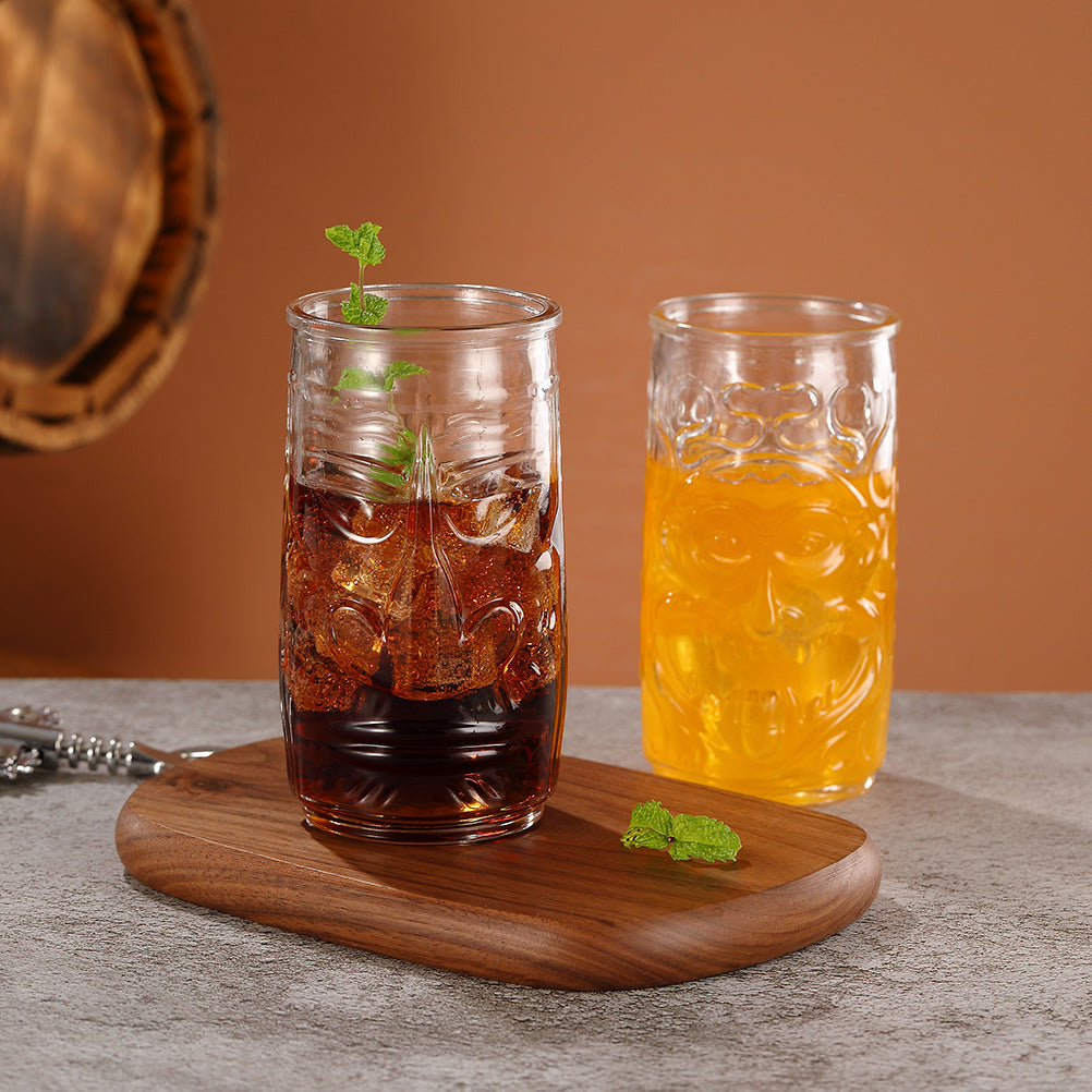 Transparent drinkware featuring unique embossed face designs in six cylindrical glass mugs.