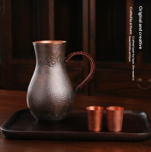 Purple liquor pot with hammered copper finish and elegant handle, ideal for serving wine and spirits.