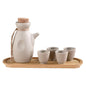Japanese sake pot set displayed on a bamboo tray with four ceramic cups, perfect for traditional drinkware.