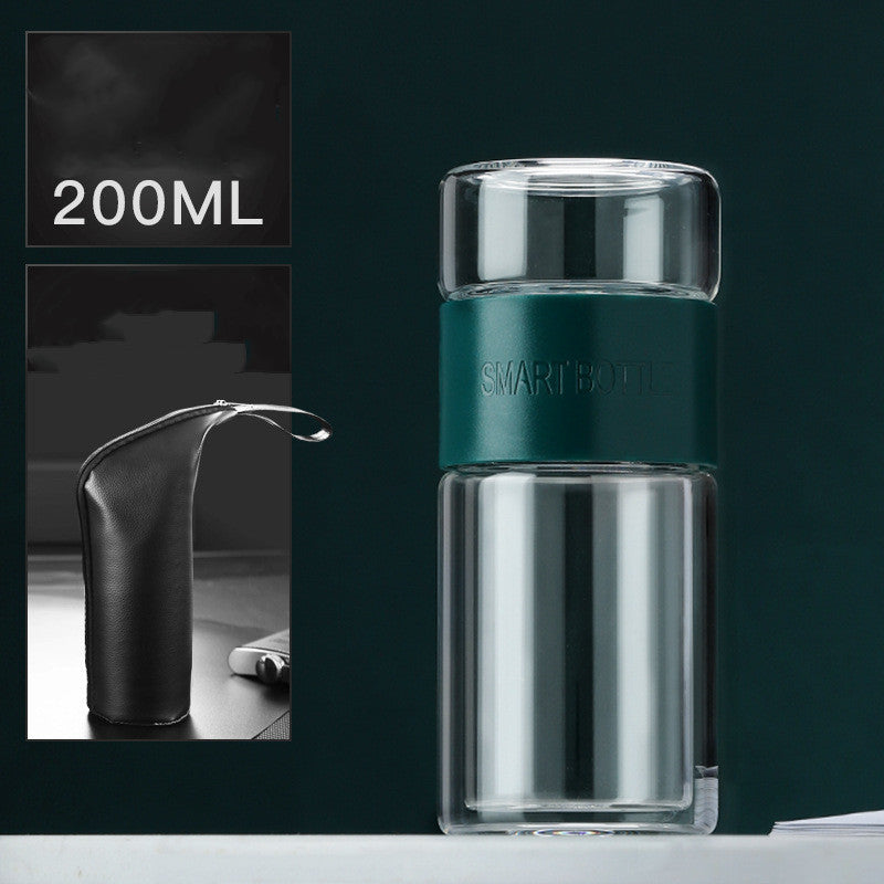 Portable travel drinkware set featuring high borosilicate glass tea tumbler and protective sleeve on a wooden table.