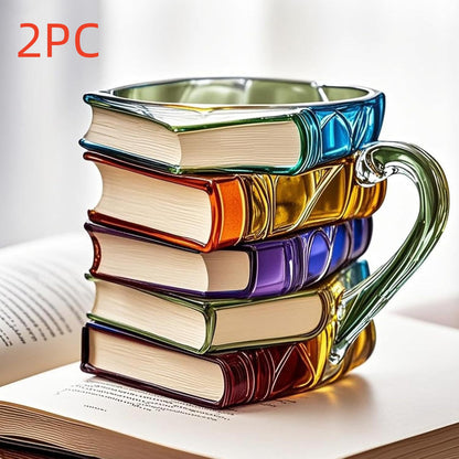 Book shaped glass mug featuring a colorful 3D design resembling a stack of illustrated books.