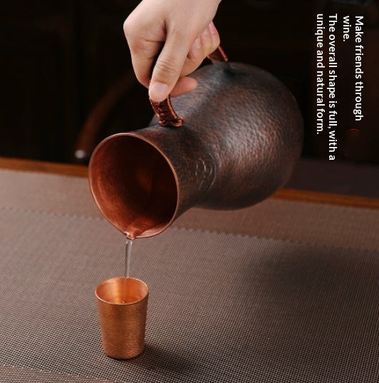 Purple liquor pot with hammered copper finish and elegant handle, ideal for serving wine and spirits.
