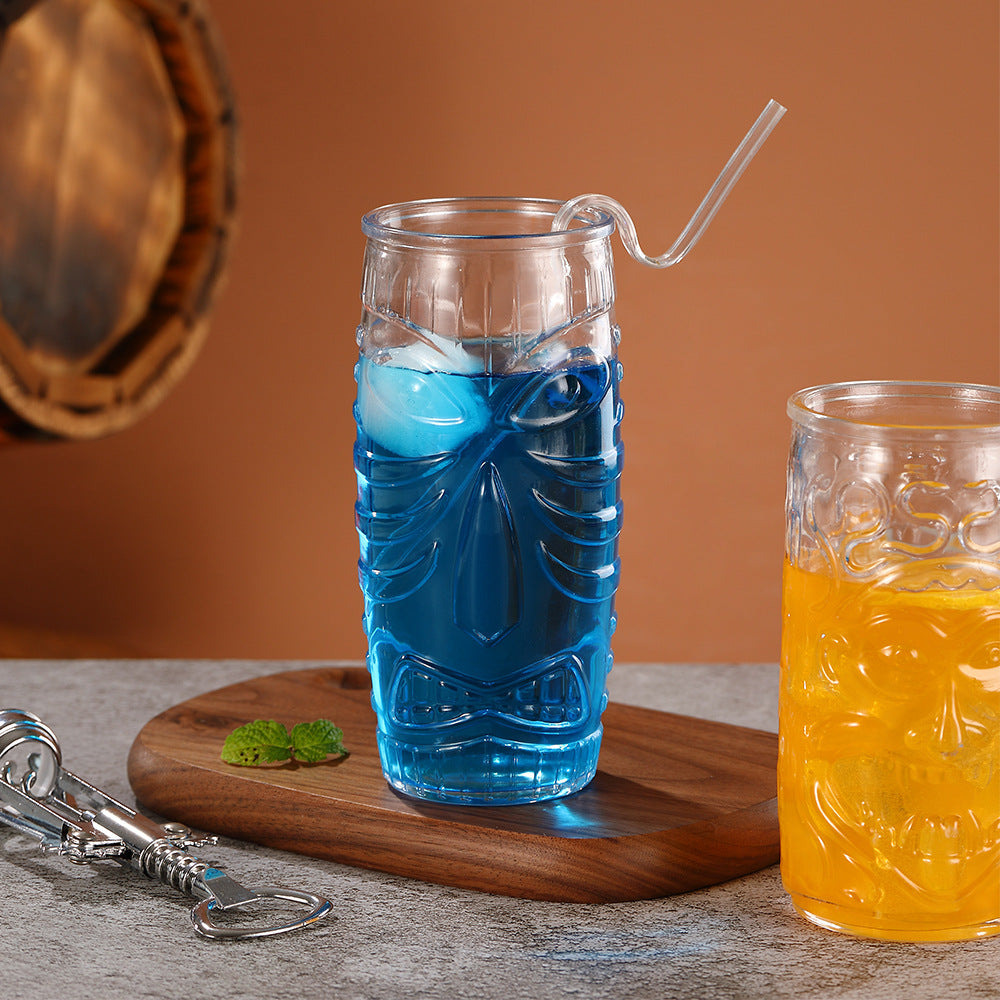 Transparent drinkware featuring unique embossed face designs in six cylindrical glass mugs.