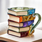 Book shaped glass mug featuring a colorful 3D design resembling a stack of illustrated books.