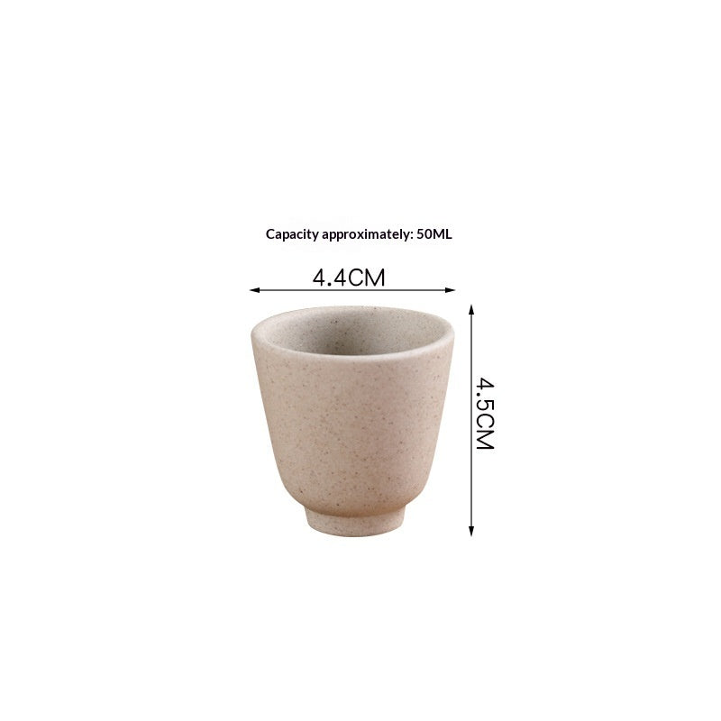 Japanese sake pot set displayed on a bamboo tray with four ceramic cups, perfect for traditional drinkware.