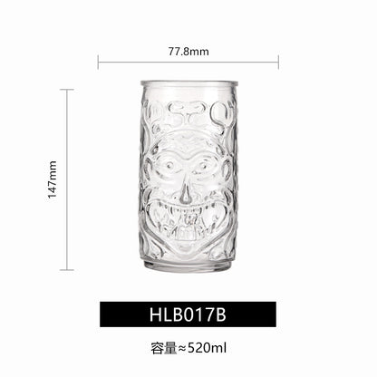 Transparent drinkware featuring unique embossed face designs in six cylindrical glass mugs.